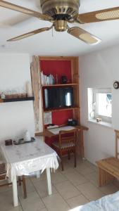 a living room with a table and a desk at Highland Accommodation Bavaria in Weilheim in Oberbayern