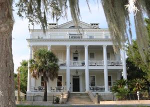 a large white house with trees in the foreground at Anchorage 1770 in Beaufort