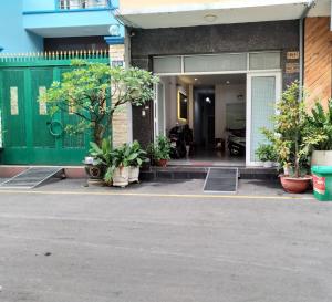a front entrance to a building with potted plants at Eco SaiGon Apartments in Ho Chi Minh City