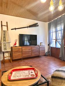 a living room with a tv and a table at Duplex a la plaça Major in El Pont de Suert