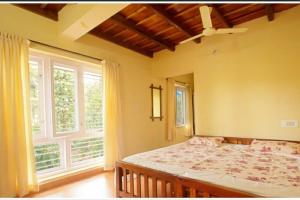 1 dormitorio con cama y ventana grande en Daisy Land - Farm Stay. (Group of 4+ guests), en Cherambane