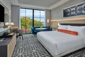 a bedroom with a large bed and a living room at The Crescent Hotel, Fort Worth in Fort Worth