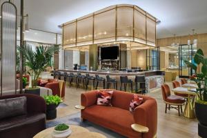 a lobby with a bar in the background at The Crescent Hotel, Fort Worth in Fort Worth
