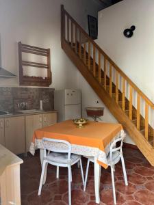 a kitchen with a table with chairs and a staircase at DONNA FELICIA in Pachino