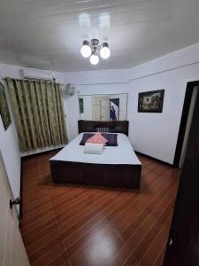 a bedroom with a large bed in a room at Country Bug Inn in Tagaytay