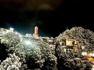 a building on top of a mountain at night at Landour Exotica in Mussoorie
