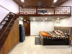 a bedroom with a bunk bed and a staircase at Landour Exotica in Mussoorie