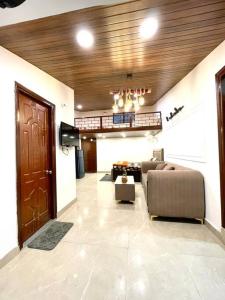 a living room with a couch and a table at Landour Exotica in Mussoorie +7 photos