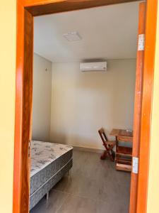 Zimmer mit einem Bett, einem Schreibtisch und einem Tisch in der Unterkunft Casa de Praia Maceió in Maceió