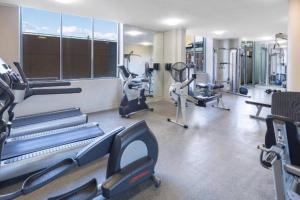 a gym with treadmills and machines in a room at Super comfortable quiet room in Sydney