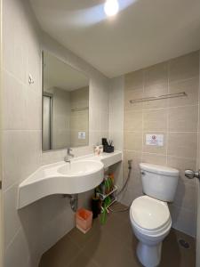 a bathroom with a sink and a toilet and a mirror at Annahome1@Latkrabang in Lat Krabang
