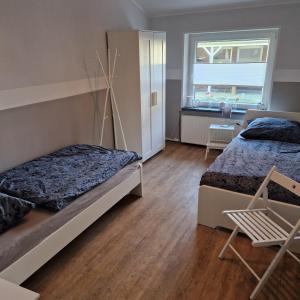 1 dormitorio con 2 camas y ventana en Moorparadies FRI-Südliches Friesland, en Bockhorn
