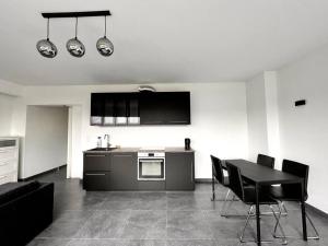 a kitchen with a table and a stove top oven at Stylish Fully Equipped Studio Close to Centre in Luxembourg