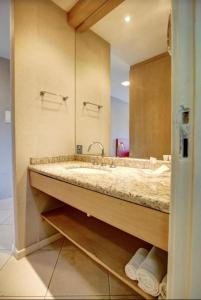 a bathroom with a sink and a large mirror at Confort Suite autônoma Quality Rio Centro in Rio de Janeiro +7 photos