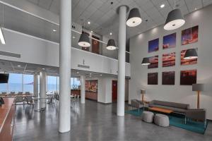 a lobby with a couch and tables and chairs at City Express by Marriott Veracruz in Veracruz