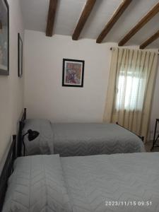 a bedroom with a bed and a window at VILLA VIOLA B & B in Baganzola