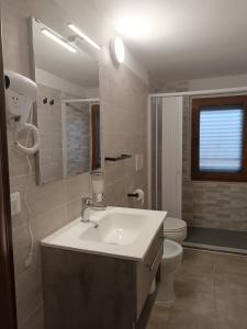 a bathroom with a sink and a toilet at VILLA VIOLA B & B in Baganzola