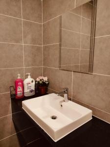 a bathroom with a white sink and a mirror at Onsen Studio @ Lost World of Tambun in Tambun