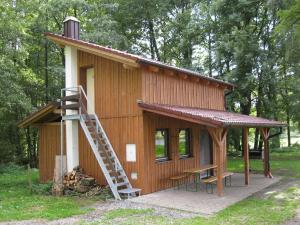 a small wooden cabin with a staircase leading to it at Chata Česká Kubice in Česká Kubice