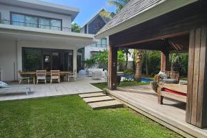 a house with a patio with a table and chairs at Villa golf de Montchoisy in Mont Choisy