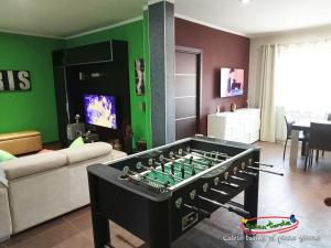 a living room with a large foosball table at Relax nel verde in Bracciano