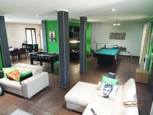 a living room with couches and a pool table at Relax nel verde in Bracciano