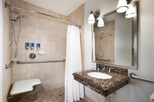 a bathroom with a sink and a shower at Four Points by Sheraton Kansas City Airport in Kansas City