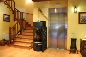 a living room with a fireplace and a staircase at Hotel Rantiner in Taüll