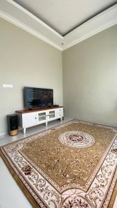 ein Wohnzimmer mit einem großen Teppich auf dem Boden in der Unterkunft Ghani Villa in Tlekung