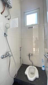 a bathroom with a shower and a toilet at Ghani Villa in Tlekung +8 photos