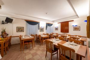 a dining room with wooden tables and chairs at Villa Fontana in Trogir