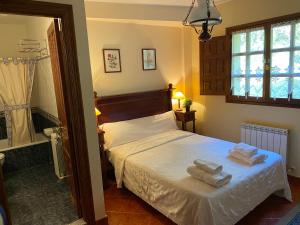 a bedroom with a bed with towels on it at LOS CARBAYINOS in Villaviciosa