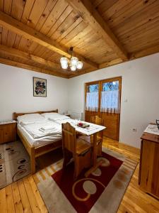 a bedroom with a bed and a table in it at Mrestilište Vareš in Vareš