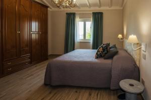 a bedroom with a bed and a window at Poggio al Sole in Montespertoli