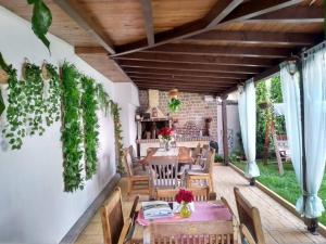 a dining room with a table and chairs on a patio at Family Hotel Flora in Zlatograd