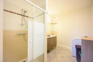 uma casa de banho com um chuveiro e um lavatório. em Le Capeyron - Parking - WIFI - Aéroport em Mérignac
