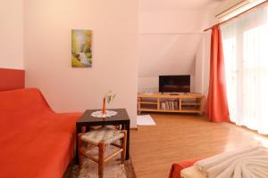 a living room with a couch and a table at Family Hotel Flora in Zlatograd