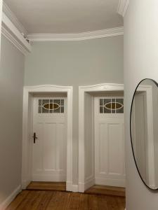 a room with two doors and a mirror at Bismarcks Berlin in Berlin