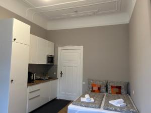 a small bedroom with a bed and a kitchen at Bismarcks Berlin in Berlin