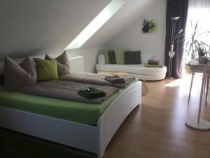 a living room with a bed and a couch at Ferienwohnung mit Blick auf den Kickelhahn in Ilmenau