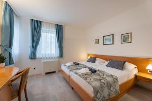 a hotel room with two beds and a table at Villa Fontana in Trogir +53 photos