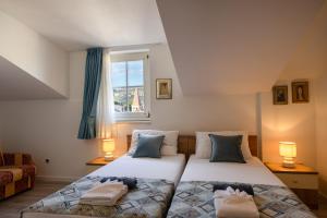 a bedroom with two beds and a window at Villa Fontana in Trogir