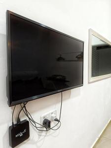 a flat screen tv hanging on a wall at PD ROOM STAY in Port Dickson