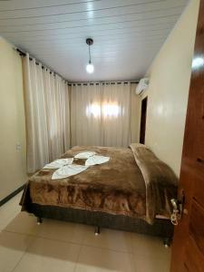 a bedroom with a large bed in a room at Pousada Portal da Chapada in Rio de Contas