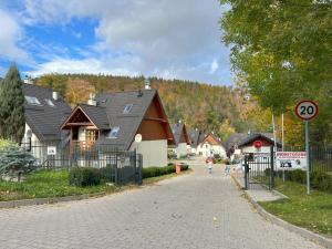 a street in a village with a house at IKS holiday in Karpacz