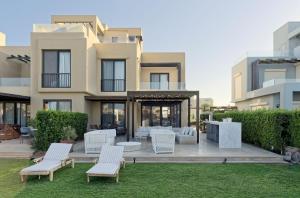a villa with a lawn in front of a building at Vesta - El Gouna Residence in Hurghada