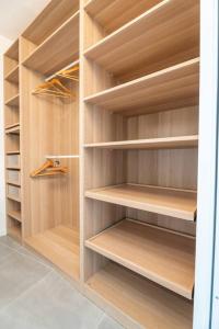 a walk in closet with wooden shelves at Modernity & Comfort Downtown Aix en Provence in Aix-en-Provence