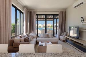 a living room with a couch and a tv at Vesta - El Gouna Residence in Hurghada