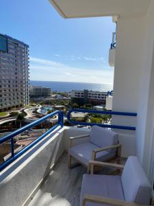 a balcony with chairs and a view of the ocean at Paraiso Suites with Mega Views, Sea and Mountain. in Playa Paraiso