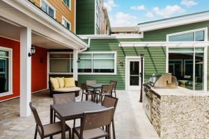 a patio with a table and chairs and a grill at Residence Inn by Marriott New Haven Hamden in Hamden